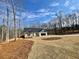 A bright, single-story home with a two-car garage is framed by a well-maintained front yard and wooded backdrop at 3382 Milan Ct, Douglasville, GA 30135