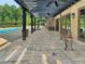 Enjoy outdoor living with a covered patio, stone floors, and scenic backyard views at 3382 Milan Ct, Douglasville, GA 30135