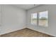 Bright bedroom featuring wood-look floors and two windows with a lovely view at 367 River Walk Farm Lot 8 Pkwy, Covington, GA 30014