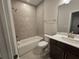 Bathroom with tiled shower/tub combination, single sink, and a modern design at 3687 Thornhill Ct, Douglasville, GA 30135