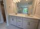 Bright bathroom with dual sinks, white cabinets, quartz countertops, and a large mirror at 3687 Thornhill Ct, Douglasville, GA 30135