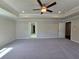 Large bedroom with tray ceiling, recessed lighting, and adjoining doorways at 3687 Thornhill Ct, Douglasville, GA 30135