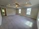 Primary bedroom featuring a tray ceiling and three windows, creating a bright space at 3687 Thornhill Ct, Douglasville, GA 30135