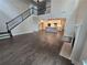 Spacious living room featuring an open floor plan, dark wood floors, and a staircase at 3687 Thornhill Ct, Douglasville, GA 30135