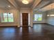 Elegant living room with dark hardwood floors and large windows, great for entertaining at 3687 Thornhill Ct, Douglasville, GA 30135