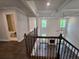 Upstairs living area showcasing a vaulted ceiling, fireplace, and views of the yard at 3687 Thornhill Ct, Douglasville, GA 30135