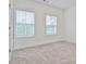 Spacious bedroom featuring soft carpet, two large windows for natural light at 4360 Sims Park Overlook, Suwanee, GA 30024