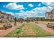 Community space featuring lush green grass, walkways, benches, and elegant lighting at 4360 Sims Park Overlook, Suwanee, GA 30024