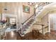 Grand foyer showcasing a staircase, hardwood floors and decorative wallpaper at 8185 Habersham Waters Rd, Atlanta, GA 30350