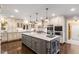 Spacious gourmet kitchen boasts custom cabinets, granite counters, and stainless steel appliances at 8185 Habersham Waters Rd, Atlanta, GA 30350