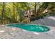 Inviting in-ground pool nestled in a lush, wooded backyard setting, perfect for relaxation at 8185 Habersham Waters Rd, Atlanta, GA 30350