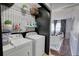 Well-organized laundry room with washer, dryer, shelving, and stylish wallpaper at 120 Sunflower Ln, Covington, GA 30016