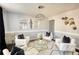 Bright living room with a designer rug, glass table, decorative mirrors, and stylish white chairs at 120 Sunflower Ln, Covington, GA 30016