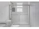 Bathroom featuring glass shower door, white tile and patterned wallpaper at 1598 Jonesboro Se Rd, Atlanta, GA 30315