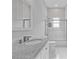 Clean bathroom with a granite countertop, white cabinets, and a glass shower door at 1598 Jonesboro Se Rd, Atlanta, GA 30315
