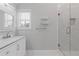 Bright bathroom featuring a shower, marble counter and floors, and a window at 1598 Jonesboro Se Rd, Atlanta, GA 30315