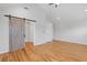 Large bedroom with vaulted ceiling, hard wood floors, and a sliding barn door at 1598 Jonesboro Se Rd, Atlanta, GA 30315