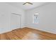 Bright bedroom with hardwood floors, a ceiling fan, and a double door closet at 1598 Jonesboro Se Rd, Atlanta, GA 30315