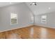 Spacious bedroom with vaulted ceilings, hardwood floors, and three windows at 1598 Jonesboro Se Rd, Atlanta, GA 30315
