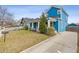 View of the home's blue siding, front yard, mailbox, and a concrete driveway to the rear at 1598 Jonesboro Se Rd, Atlanta, GA 30315