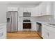 Contemporary kitchen with stainless steel appliances, white cabinets, and a stylish subway tile backsplash at 1598 Jonesboro Se Rd, Atlanta, GA 30315