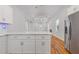 Open-concept kitchen with marble countertops, stainless steel refrigerator, and hardwood floors leading to the living area at 1598 Jonesboro Se Rd, Atlanta, GA 30315
