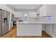 Modern kitchen with white cabinets, stainless steel appliances, marble counters and backsplash at 1598 Jonesboro Se Rd, Atlanta, GA 30315