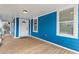Charming covered front porch with wood flooring, blue siding and a white front door at 1598 Jonesboro Se Rd, Atlanta, GA 30315