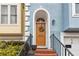 Home's inviting front entrance features a stylish brown door with a floral wreath and brick steps at 3783 Meeting St, Duluth, GA 30096