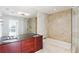 Elegant bathroom featuring double sinks, a soaking tub, and glass shower at 3325 Piedmont Ne Rd # 1502, Atlanta, GA 30326