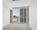 Bedroom features a large window with expansive city views and neutral carpet at 3325 Piedmont Ne Rd # 1502, Atlanta, GA 30326