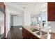 Kitchen island featuring granite countertop, stainless steel sink, and hardwood floors at 3325 Piedmont Ne Rd # 1502, Atlanta, GA 30326