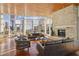 Modern living room with floor-to-ceiling windows, a stone fireplace, and city views at 3325 Piedmont Ne Rd # 1502, Atlanta, GA 30326