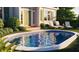 Inviting backyard pool surrounded by lush landscaping, lounge chairs and a charming home facade at 362 Old Ivy Ne Rd, Atlanta, GA 30342