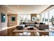 Bright living room with a large sectional sofa, hardwood floors, and oversized windows with outdoor views at 362 Old Ivy Ne Rd, Atlanta, GA 30342