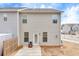 Features a small concrete patio with a chair, a fenced-in area, and light gray siding of the home at 539 Walton Dr, Woodstock, GA 30188