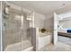 Bathroom featuring a soaking tub, a glass enclosed shower and neutral tile and bedroom view at 539 Walton Dr, Woodstock, GA 30188
