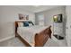 Bedroom with a wooden bed frame, TV, bedside table, and neutral walls at 539 Walton Dr, Woodstock, GA 30188