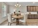 Dining room featuring a wooden table with upholstered chairs and a modern chandelier at 539 Walton Dr, Woodstock, GA 30188
