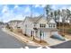 Exterior of a townhome with two-car garage, landscaped yard, and street view at 539 Walton Dr, Woodstock, GA 30188