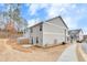 Exterior showcasing the home's backyard, concrete patio, and the light gray siding near the sidewalk at 539 Walton Dr, Woodstock, GA 30188