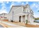 Side view of a well-maintained townhome with a charming entrance and two-car garage at 539 Walton Dr, Woodstock, GA 30188