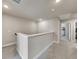 Upstairs hallway featuring neutral paint and carpeting at 539 Walton Dr, Woodstock, GA 30188