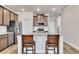 Modern kitchen with stainless steel appliances, granite countertops and an island with seating at 539 Walton Dr, Woodstock, GA 30188