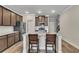 Open kitchen with granite countertops, stainless steel appliances, and island seating at 539 Walton Dr, Woodstock, GA 30188