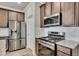 Modern kitchen with stainless steel appliances, granite countertops and a gas range at 539 Walton Dr, Woodstock, GA 30188