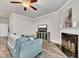 Cozy living room featuring a comfortable couch, fireplace, and a TV console at 539 Walton Dr, Woodstock, GA 30188