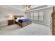 Spacious main bedroom featuring tray ceiling, fan, plush carpet and lots of natural light at 539 Walton Dr, Woodstock, GA 30188