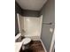Bathroom with white tub, toilet, and gray walls, providing a clean and functional space at 5768 Windgate Ln, Lithonia, GA 30058