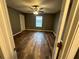 Bedroom with ceiling fan, window, and modern wood-look flooring at 5768 Windgate Ln, Lithonia, GA 30058